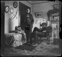 Guy West poses in the library of the West's house with his cousin, William Mead, Los Angeles, about 1900