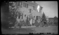 Mertie West stands in front of Frances Wells' apartment, Anchorage, 1946