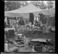 Josie Shaw and Mertie West standing beneath their camp's canopy, Mono County, 1941