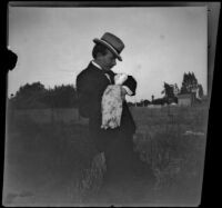 H. H. West cradles a rag doll, Los Angeles, about 1899