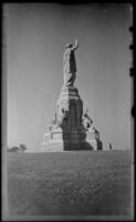 Mertie West stands at the base of the National Monument to the Forefathers, Plymouth, 1947