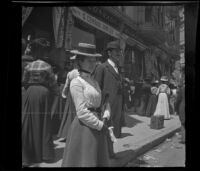 Mertie Whitaker and Ora Prickett stand on Spring Street watching the parade for President William McKinley, Los Angeles, 1901