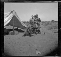 H. H. West, Dick Taylor and Ed Menshik pose behind a gun rack, San Diego County, about 1908