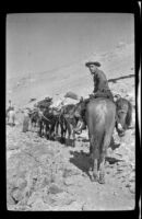 Cleo Swain looking back after the H. H. West group tops Kersearge Pass during a trip to Gardner Creek, about 1919