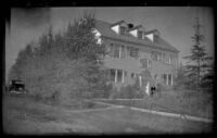 Mertie West stands outside Lingo Apartment (Frances Wells' residence), Anchorage, 1946