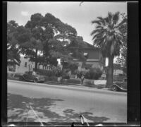 Wilson West stands in front of the West's former home, Los Angeles, 1936