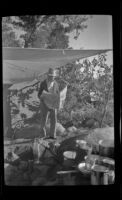 Forrest Whitaker reads a newspaper at his campsite at Rock Creek, Mammoth Lakes vicinity, 1940