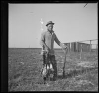 Franz O. Nelson poses for a photograph with his gun and ducks, Orange County vicinity, about 1912