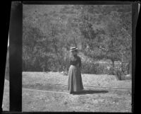 Nella West standing in a park, San Jose, about 1900