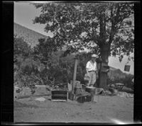 Mertie West stands at a campsite, Inyo County vicinity, about 1930