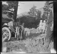 Glen Velzy handles trout at Convict Lake, Mammoth Lakes vicinity, 1915