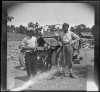 Wilfrid Cline, Jr. and H. H. West posing with trout caught from Cow Creek, Redding vicinity, 1917