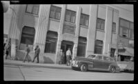 Mertie West stands outside the First National Bank of Fairbanks, Fairbanks, 1946