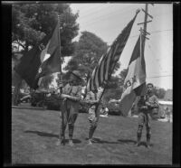 Three Boy Scouts hold flags in preparation for the Decoration Day Parade, Glendale, 1937