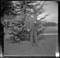 H. H. West poses on his front lawn, Los Angeles, about 1914