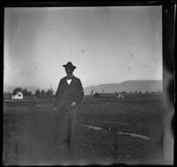 Charles Rucher poses for a photograph, Redlands vicinity, 1899