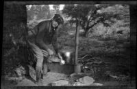 Jesse Brown caught cooking at the campsite, June Lake, about 1920