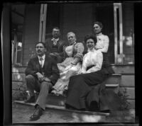 Members of the Prickett family, Mertie Whitaker and Lelia Gillan sit on the Prickett's front porch, Fresno, 1901