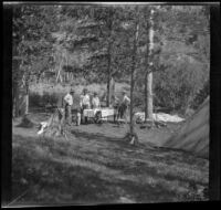Members of the West, Whitaker and Shaw party standing in the distance around their campsite, Modoc County, 1929