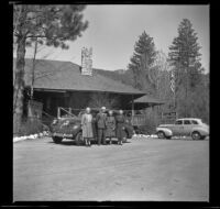 Josie Shaw, Forrest Whitaker, Mertie West and Agnes Whitaker pose in front of the bike shop, Idyllwild, 1942