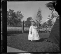 Mertie Whitaker reaches her hand to her nephew, Lester Shaw, Los Angeles, about 1896