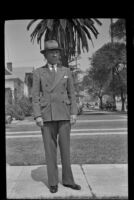 H. H. West poses with a palm tree in the background, Los Angeles, 1942