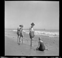 Ade Bystle and Lottie Bystle on the beach, near the water's edge, Santa Monica, about 1920