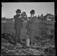 H. H. West pours a glass of wine for Earl Kellum, Los Angeles, about 1899