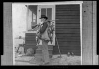 E. C. "Dick" Taylor holds a gun over his shoulder with ducks hanging from it, Venice, about 1903