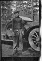 Wilfrid Cline, Jr. posing next to a car, Redding vicinity, 1917