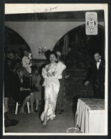 L'Tanya models a white satin dress, Los Angeles, 1940s