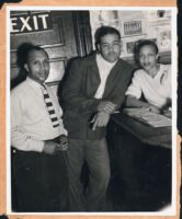 Boxer Joe Louis, Jim Goodrich (?), and an unidentified woman at a nightclub in Los Angeles, 1940s