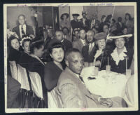 Well-dressed group dining out, Los Angeles, 1940s