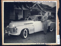 Successful businessman Dr. C. W. Hill posing with his car, Los Angeles, 1940s