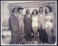 Sam Taylor, Nelson Creswell, and Lionel Hampton with waitresses, Los Angeles, 1940s