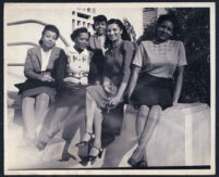 Unidentified African American women posing on a wall, Los Angeles, 1940s