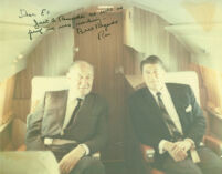 Edwin Pauley and Ronald Reagan on airplane, with handwritten inscription by Reagan