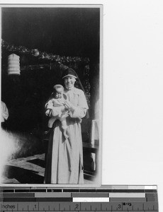A Maryknoll Sister with baby at Deqing, China, 1923