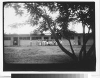 Home for Girls, children outside classroom building