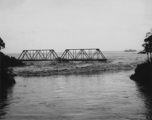 Tsunami tidal wave surging up an inlet channel, near Hilo on the Big Island of Hawaii