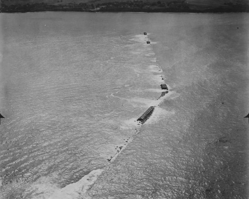 Aerial view of tsunami damage to breakwater near Hilo, Hawaii