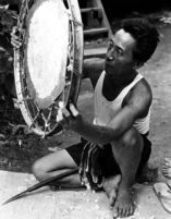 Checking the thinness of the drumhead by holding it toward the sunlight