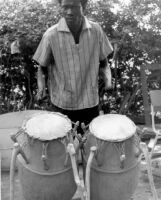 Man playing a set of two Atumpan drums — Calisphere