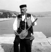 Close-up of a man, playing gusle