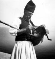 Close-up of musician in costume playing gajde or gayda