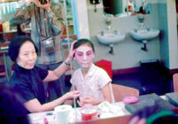 Completion of make-up for Manchurian princess for the first of Szu Lang T'an Mo (see slides L-1 to L-12)