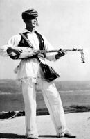 Close-up of a man playing sargija or saz