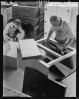 Two men assembling an icebox, 1930-1937