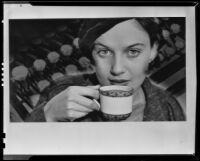 Woman lifting a porcelain cup of hot cocoa in an image created for a Ghirardelli advertisement