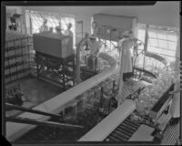 Assembly line workers filling bottles of drinking water at the Arrowhead-Puritas plant, Los Angeles, 1929-1939